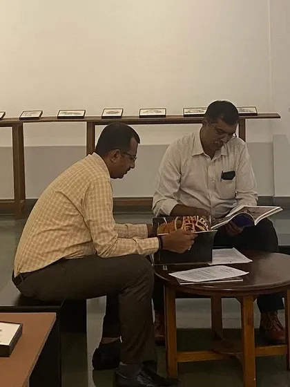 Visitors reading the artist books at the 'Quieter than Silence' exhibition by Shakuntala Kulkarni.