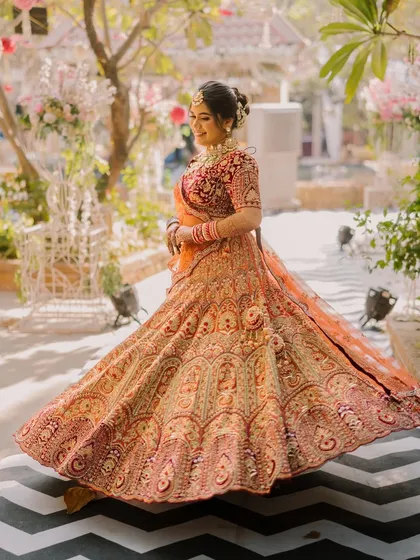 A fun, twirling shot that shows the movement and grace of the bridal outfit. The makeup remains flawless, proving its durability for a long day of celebration.