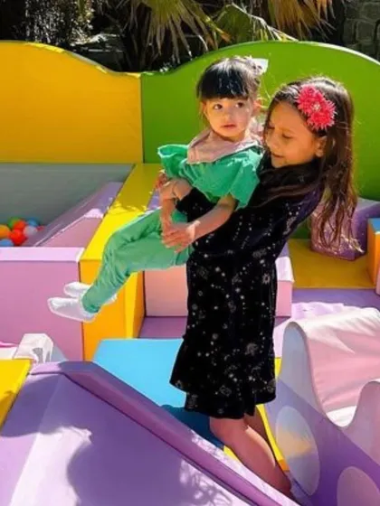 Big smiles and helping hands! Our play areas are great for siblings and friends to play together safely.