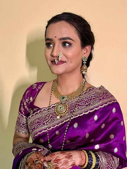 A subtle yet natural makeup look for this bride in a stunning purple saree. The makeup enhances her features without being heavy.