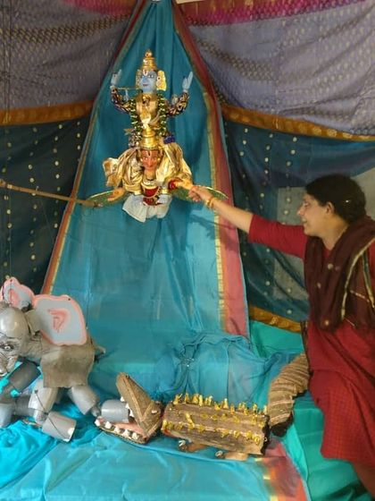 Here I am arranging a puppet display depicting the story of Gajendra Moksha. Each exhibit is a labor of love, carefully set up to convey the narrative and emotion of the scene.