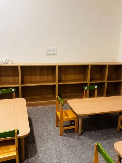 Here is a classroom in progress, with child-sized tables and chairs set up. We also installed low, open shelving units to ensure toys and learning materials are easily accessible to the children.