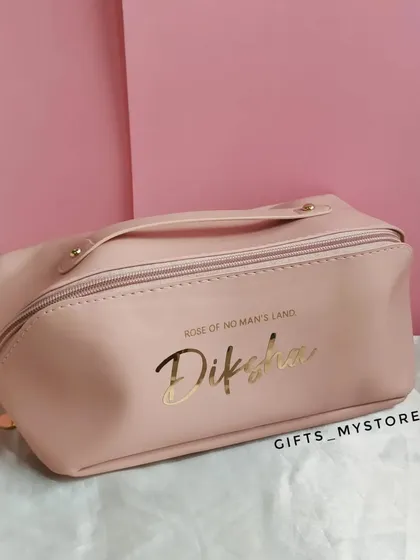 A chic pink makeup or travel pouch, personalized with her name in a beautiful gold script.