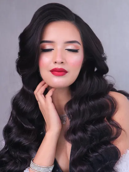 An elegant, soft-focus shot of the red carpet look, highlighting the classic beauty of the style.