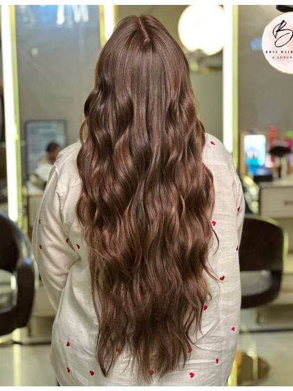 From the back, the full length of this luminous brown hair shows off its health, shine, and gorgeous waves.