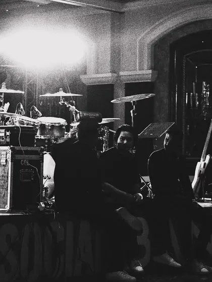 A black and white shot of the stage before the show begins. This highlights the drum kit, amps, and the professional gear we bring to every corporate gig.