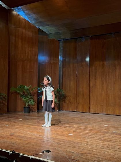 A solo singer captivates the audience, her voice filling the auditorium.