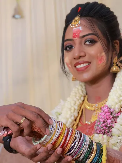 A candid moment from Aarthi's baby shower ceremony. Even with the traditional nalangu rituals, her makeup stayed put and looked fresh and vibrant.