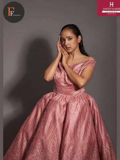 A model in an elegant pink ball gown, with hair and makeup by our students for a professional portfolio shoot.