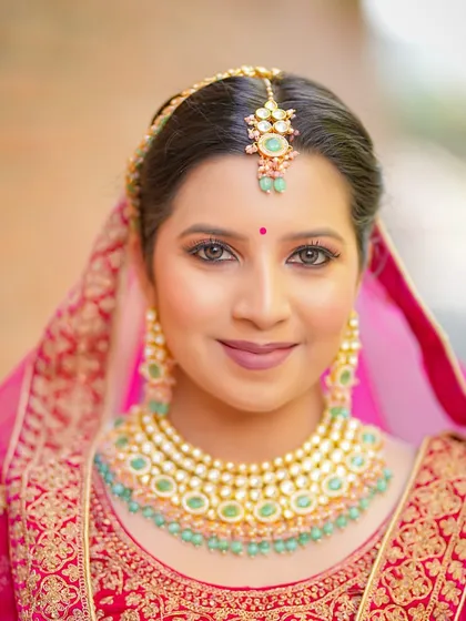 A stunning close-up of the bridal makeup, featuring flawless skin, soft eye makeup, and beautiful Kundan jewellery.