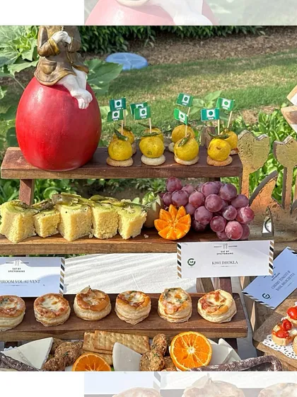 We pay attention to every detail. This tiered stand displays a variety of appetizers, including mushroom vol-au-vents and dhokla, perfect for a store launch or corporate event.