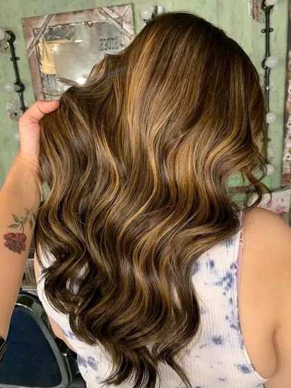 A side view of the color correction, showing the beautiful blend of tones and the healthy shine of the hair.