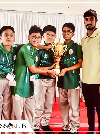 Ahaan's team with their coach and the runner up trophy. This picture captures the teamwork and guidance that are central to our coaching philosophy at ChessKlub.