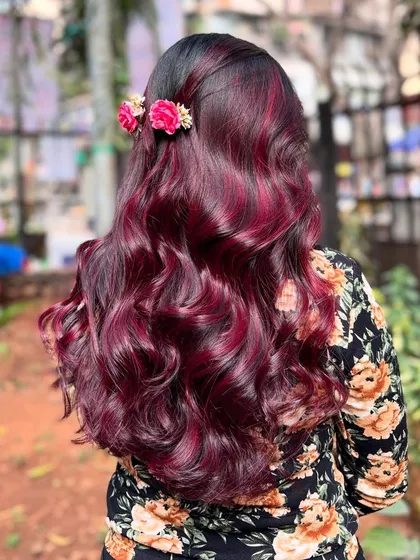 Obsessed with this wine red hair color. Styled with soft waves and floral accessories, it's a romantic and beautiful look.
