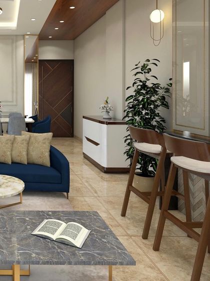 A living and dining room concept with statement furniture featuring metallic details. The design combines a blue sofa with a marble coffee table and a sleek console, creating a modern and luxurious feel.