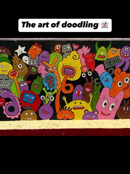 A full wall of fun, hand-painted doodle monsters. This abstract and playful style is great for adding a unique burst of energy to a creative space or a child's room.
