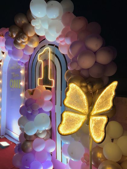 We use custom light-up elements to add that extra sparkle. This shot highlights the glowing '1' and the large illuminated butterfly, key features of our princess-themed decor.