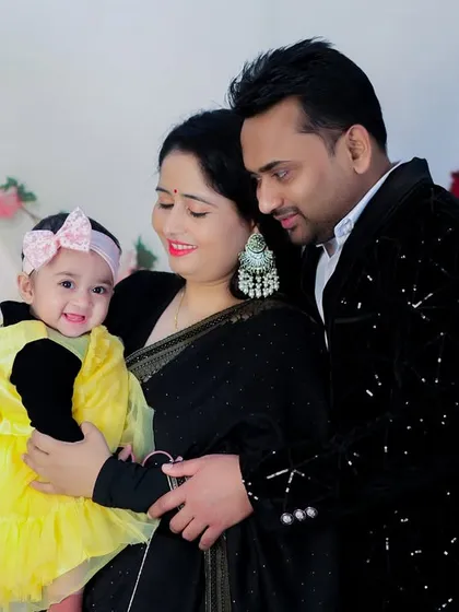 A candid, loving moment between parents and their daughter. The soft lighting and gentle interaction make this a truly heartwarming family photo.