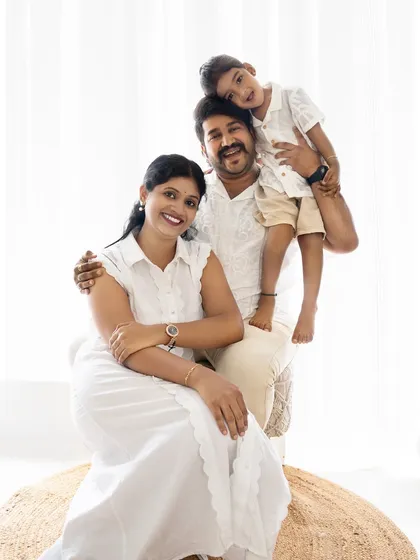 A happy family portrait with the son enjoying a piggyback ride on his dad. This pose is full of energy and joy, perfect for capturing a family's fun side.