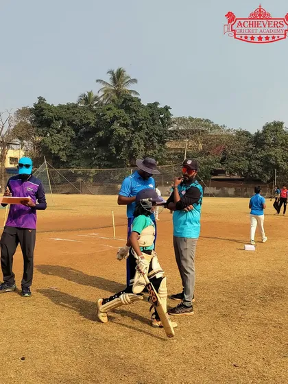 Coaches observing a young batswoman during the selection trials, looking for technique and temperament.