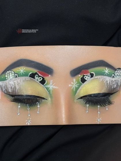 A full view of the adorable penguin and igloo eye makeup, a perfect example of the fun and creative skills learned in our courses.