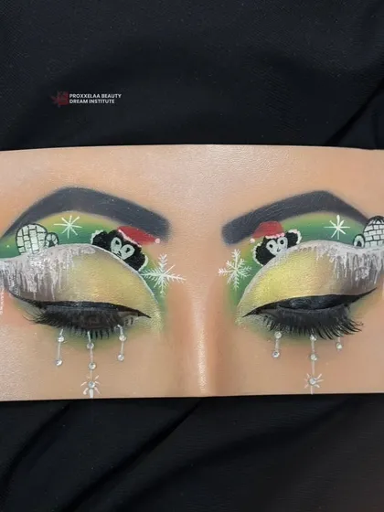 A full view of the adorable penguin and igloo eye makeup, a perfect example of the fun and creative skills learned in our courses.