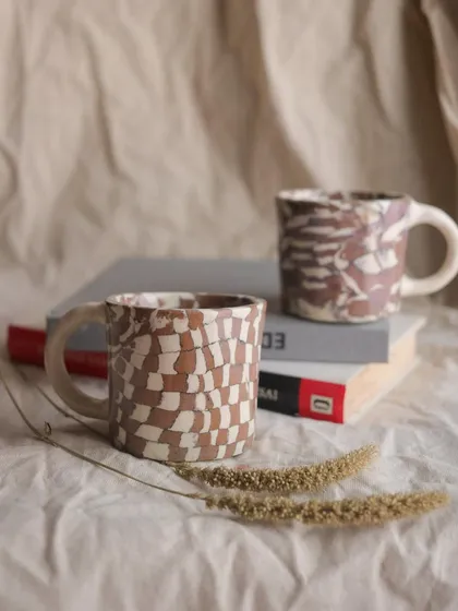 The 'Check / Uncheck' Nerikomi cup set. These little cups are perfect for an espresso shot or a cutting chai. I created the patterns by layering and slicing different colored clays.