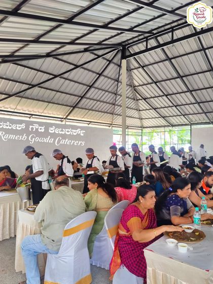Our serving team in action, ensuring every guest's plate is full. We take pride in our attentive and organized service during large gatherings.