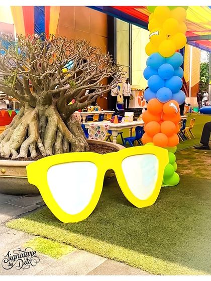 A fun, oversized prop of yellow sunglasses adds a quirky and playful touch to the Paw Patrol party decor.