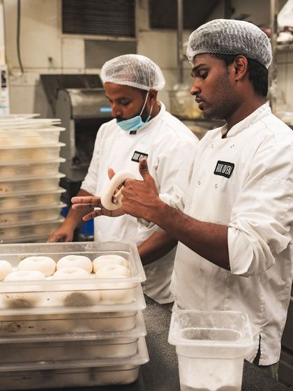 Our bakers at work, hand-rolling and shaping each bagel with care.