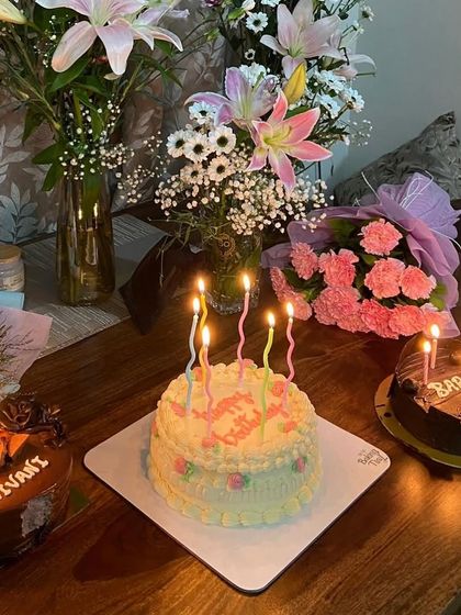 Make a wish! A beautiful scene of multiple birthday cakes lit up with candles, ready for a celebration.