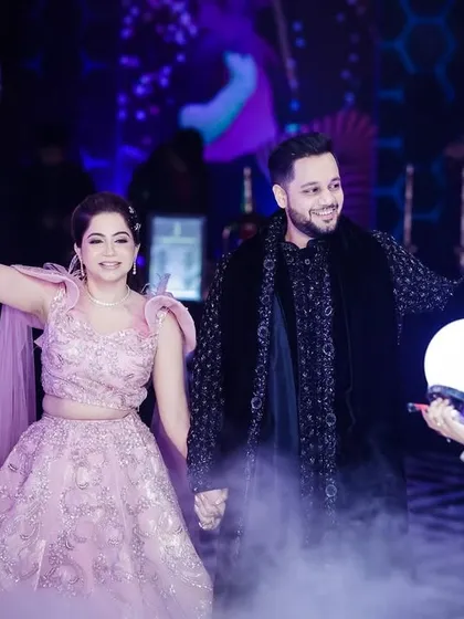 A happy and powerful shot of the couple making their entrance with CO2 guns.
