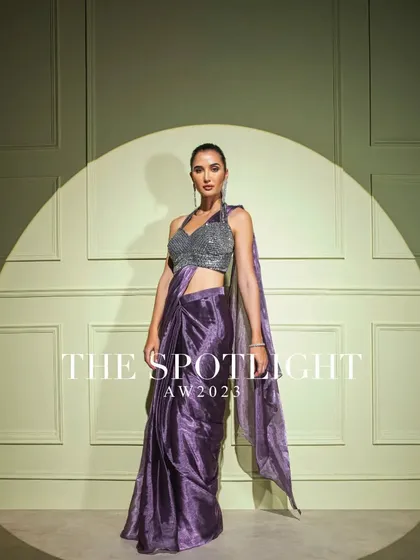 From my "Spotlight" collection, this metallic purple drape saree is paired with a silver sequined halter blouse for a show-stopping party look.