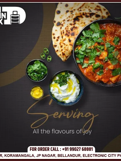 We serve all the flavours of joy in our dishes. This overhead shot captures a beautifully prepared chicken curry with fresh naan, garnished with coriander, ready to be enjoyed.