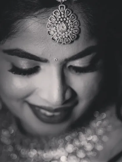 A beautiful black and white close-up of the bride, focusing on her serene expression and stunning jewelry.