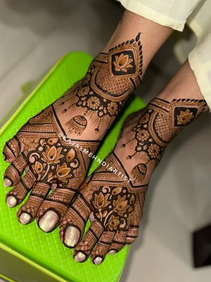 An Indian-inspired bridal leg design with hanging jhumkas and lotus flowers, perfect for any wedding ceremony.