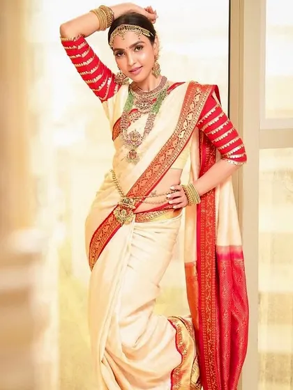 This full-length shot showcases the complete South Indian bridal attire. I provide hair styling and makeup that perfectly matches the grandeur of the outfit.
