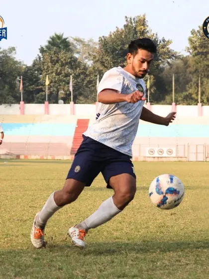 A player drives forward with the ball, showcasing skill, passion, and teamwork.