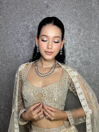 A serene shot of the same glam look. The soft, blended eyeshadow and glowing highlighter catch the light beautifully.