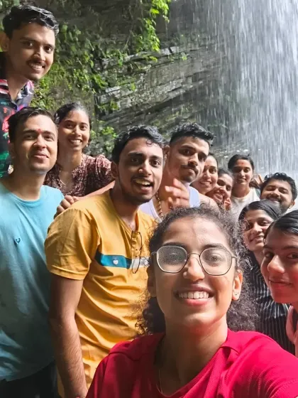 A selfie moment for a group of friends at a waterfall. Our treks are perfect for making memories with your favorite people.
