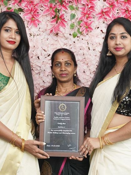 A student from Batch 12, dressed in a traditional Kerala saree, receives her certificate. My course covers diverse South-Indian bridal styles.