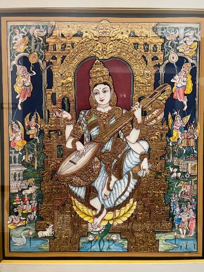 An exquisite blend of pure gold leaf embossing and delicate watercolors, this Mysore painting of Goddess Saraswathi captures the beauty of divinity in every intricate detail.