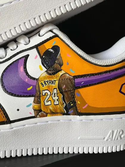 A close-up of the Kobe Bryant tribute sneakers, showing the detail on his jersey and the confetti background.