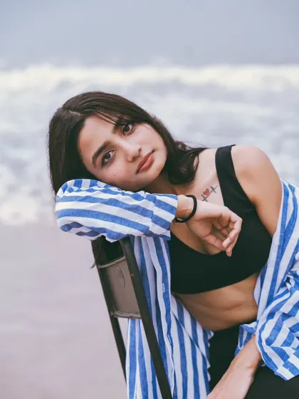 Using a simple chair as a prop can completely change the dynamic of a beach shoot, adding an element of surrealism and high fashion.