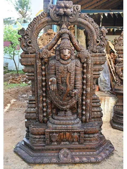 Our 79-inch standing Lord Venkatajalapathy sculpture is carved with immense devotion and detail. Finished in a classic wax brown, this statue showcases the intricate ornamentation and serene divinity characteristic of South Indian temple art.