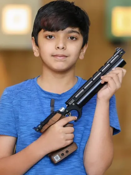 We believe in nurturing talent from a young age. This young athlete is handling a professional-grade air pistol, showcasing the safety and confidence we build in our shooters, with training open for competitors from 10 years and up.