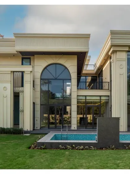 Another view of the Sultanpur masterpiece, showcasing the symmetry and elegance of the facade. The design includes a private pool that is perfectly integrated with the home's classical architecture and manicured lawn.