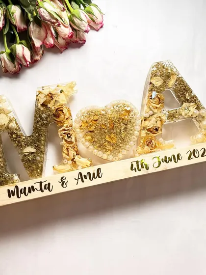 This is currently my favorite preservation style. The couple's initials and a heart, all filled with their wedding flowers and set on a wooden lamp base with their names and wedding date.