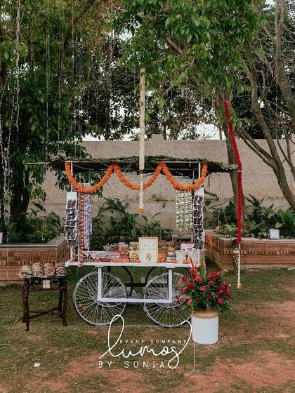 A wide shot of the 90s candy cart in the garden, a whimsical and delightful surprise for guests.