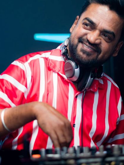 A candid shot of me mixing, with a smile that says I love what I do. Creating these moments of joy is my passion.